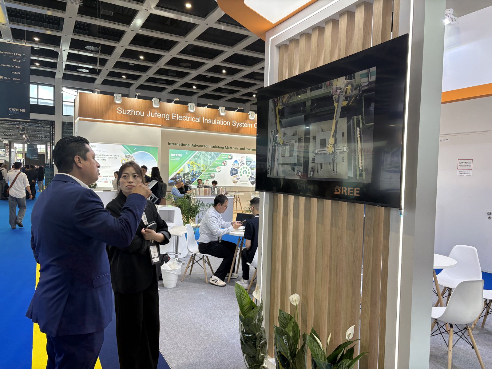 The SREE stand at CWIEME Berlin 2026 with a video screen showing a cut-to-length line