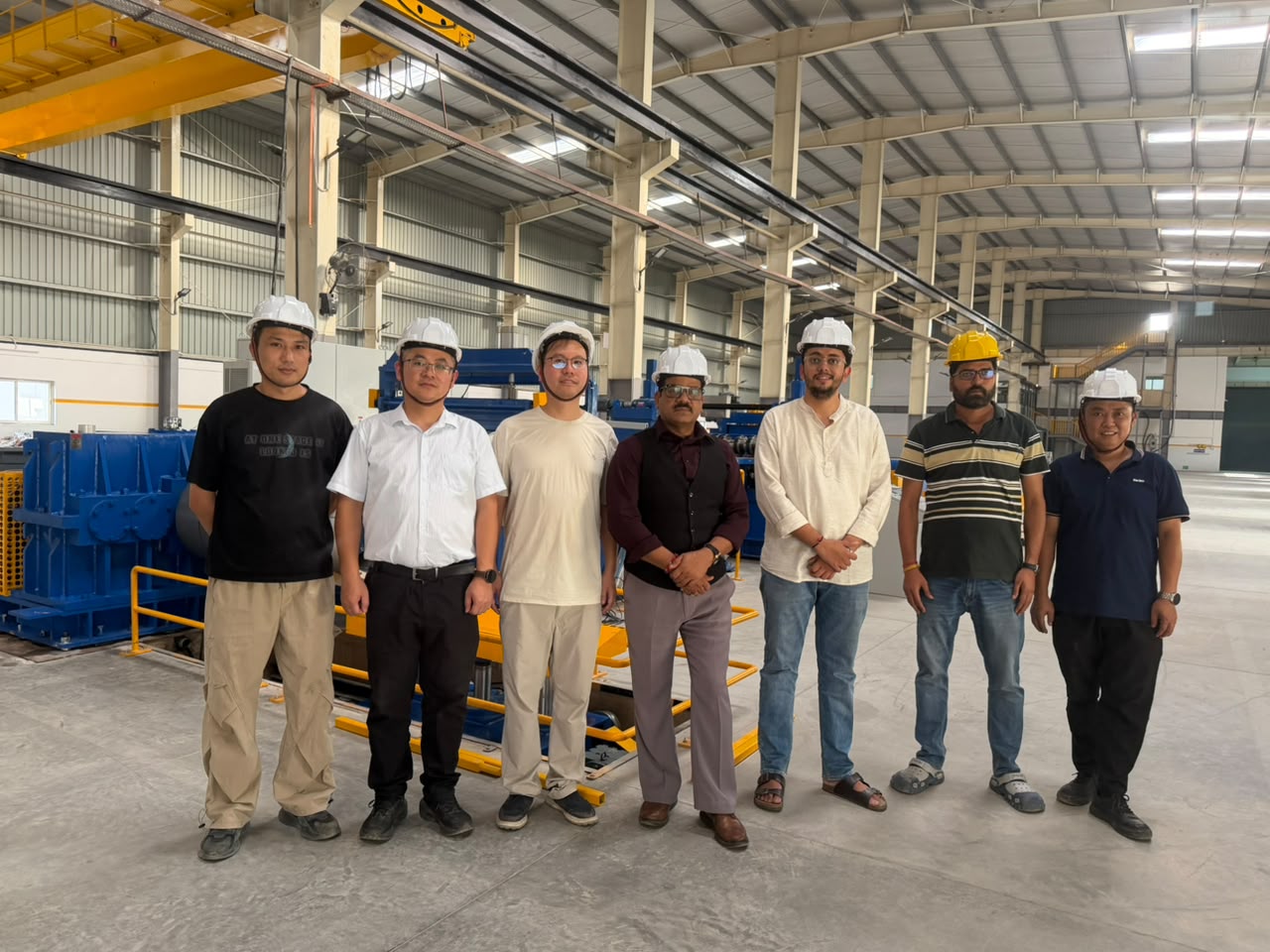 SREE and customer team members beside the installed silicon steel slitting line in India